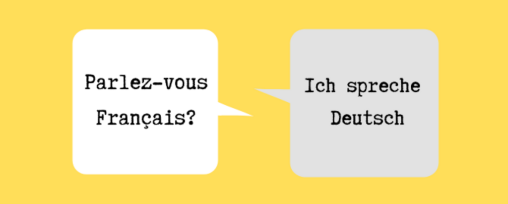 Skilt med tekst: Ich spreche deutsch Parlez vous francais